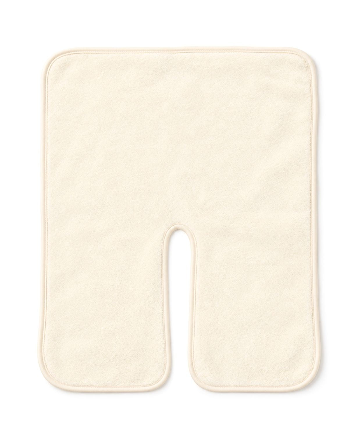 An off-white U-shaped contoured massage pillow on a solid white 