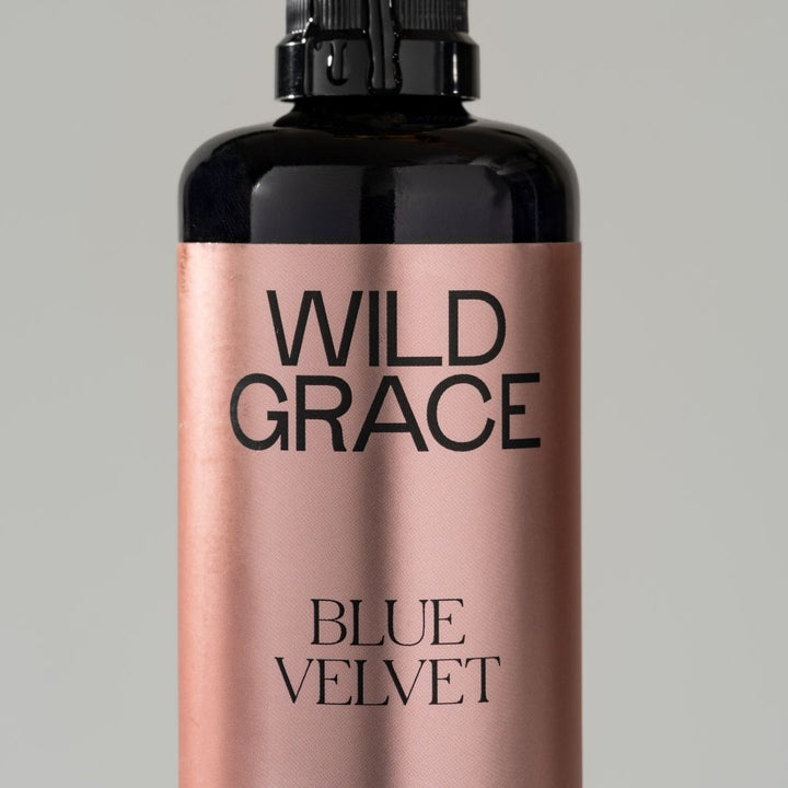 Bottle of Wild Grace Blue Velvet product on a gray background