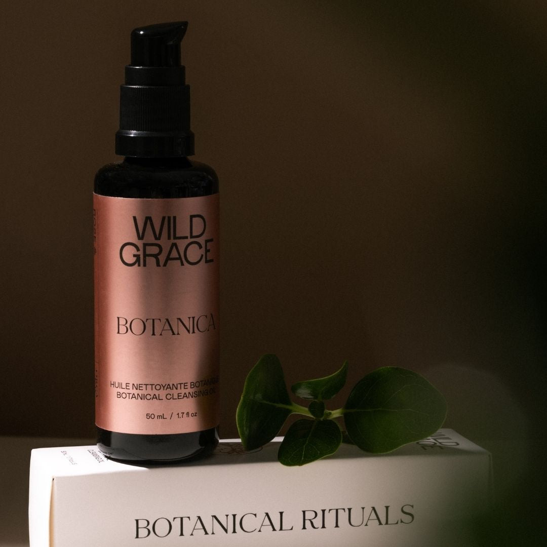 Wild Grace Botanical bottle on a box with a leaf on a brown background
