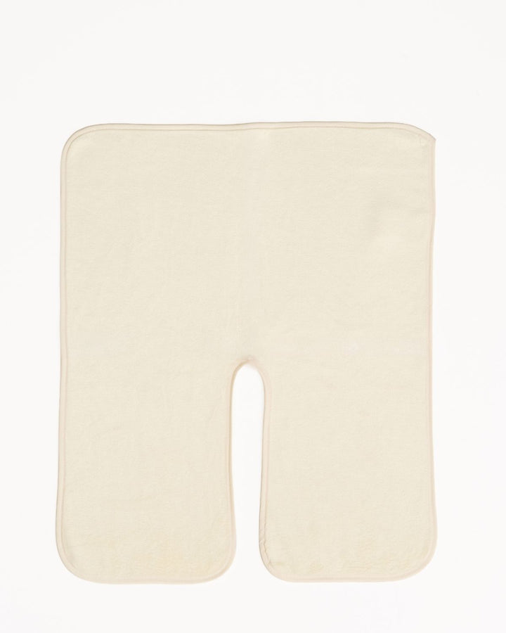 An off-white U-shaped contoured massage pillow on a solid white background.