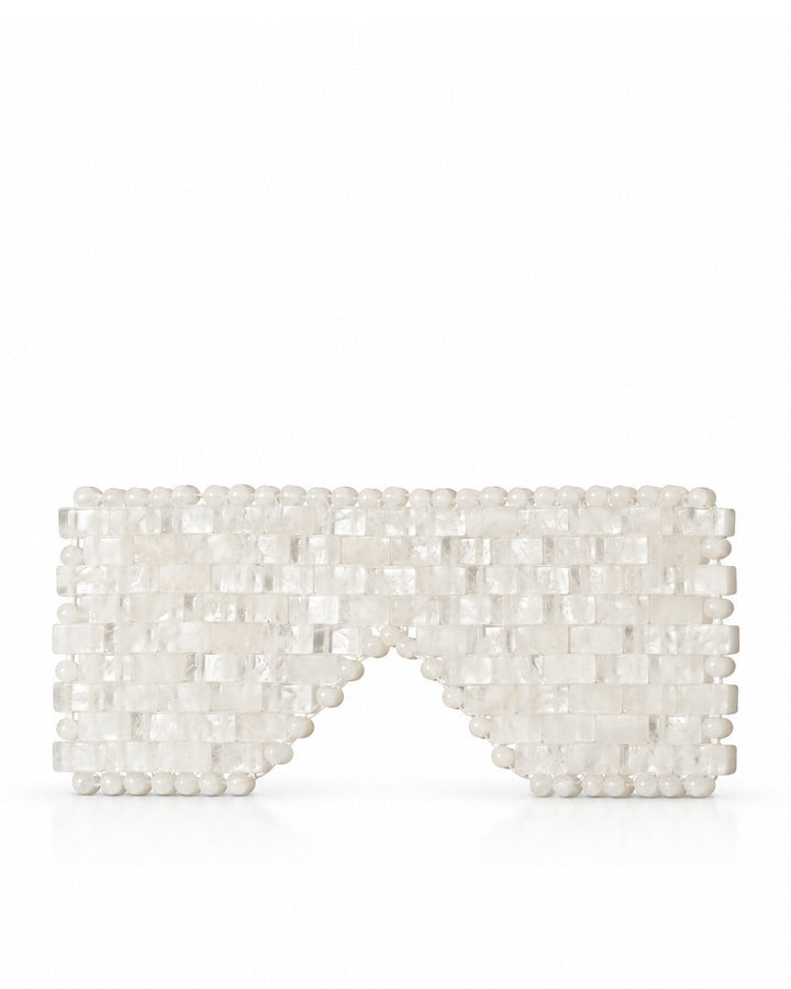 A white beaded clutch bag with a geometric, textured design and a pointed bottom, displayed on a clean white reflective surface.
