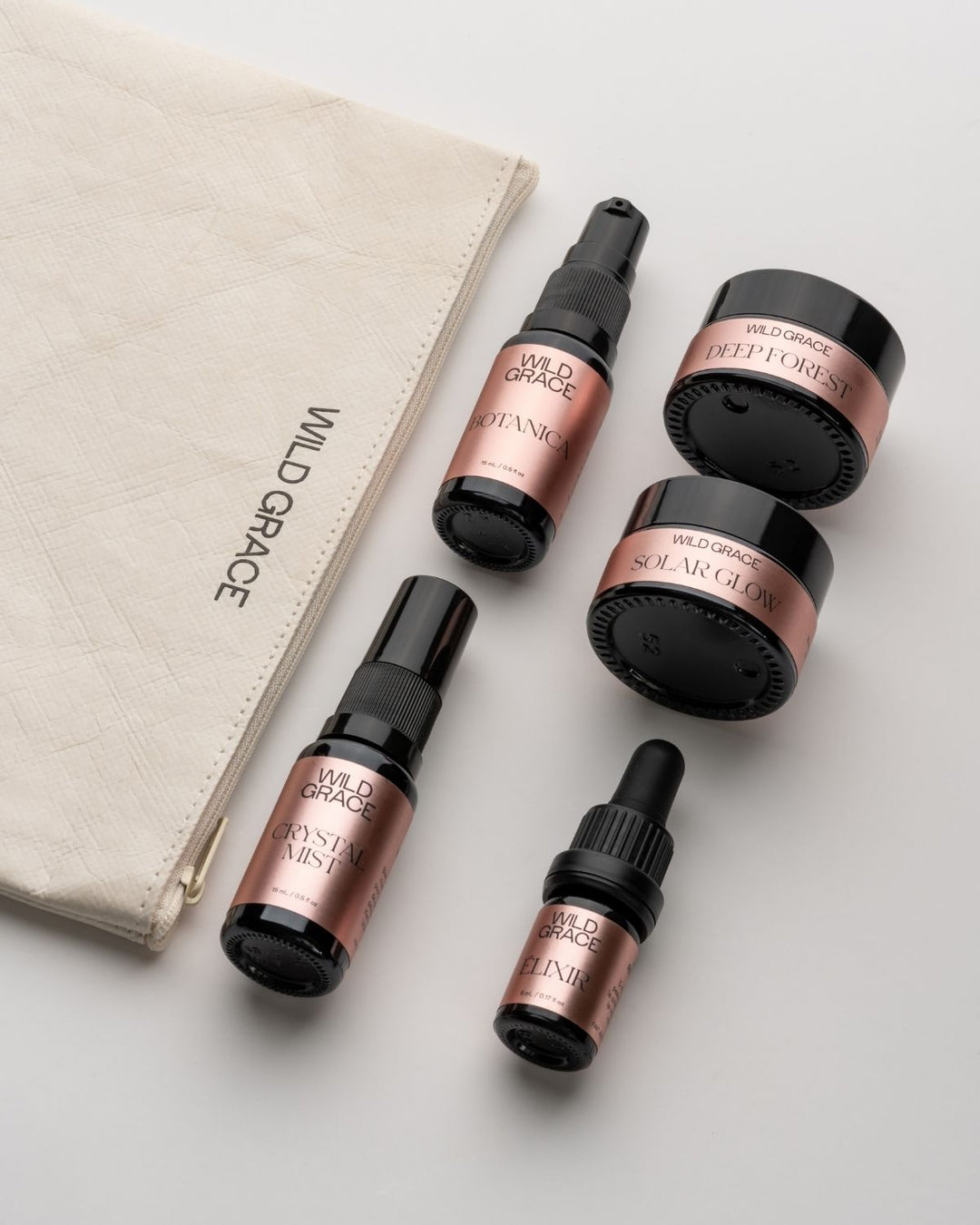 Set of Wild Grace skincare products including bottles and jars on a light background