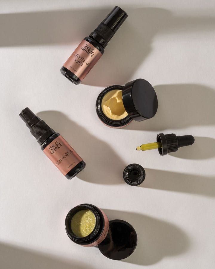 Cosmetic products including bottles and jars with visible labels on a light background