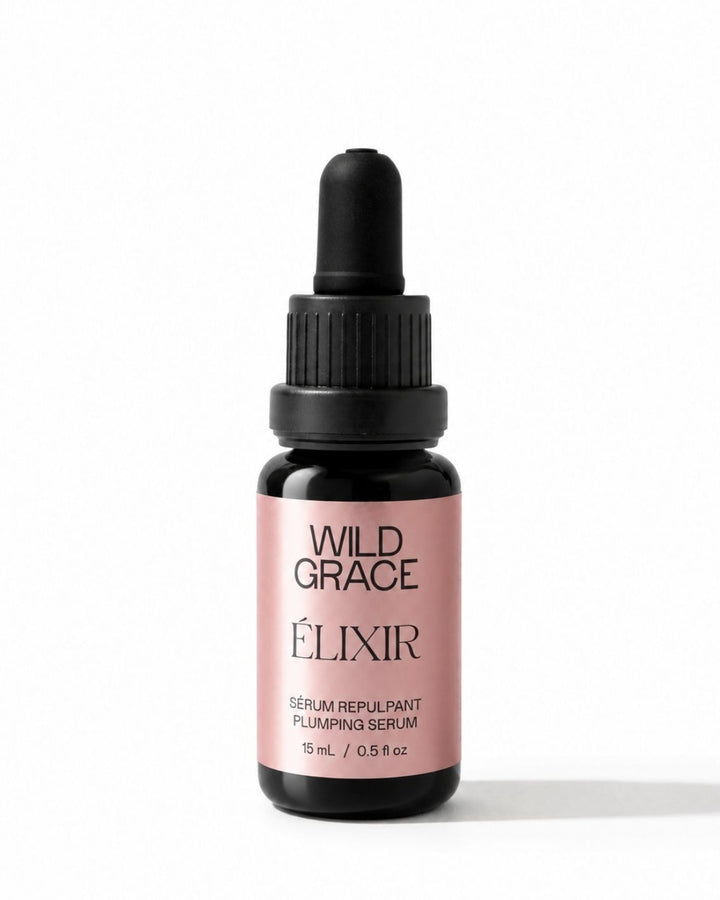 A small dropper bottle of Wild Grace Elixir Serum Repulant on a clean white background. The bottle is dark amber glass with a black dropper cap and a dusty pink label featuring black text.