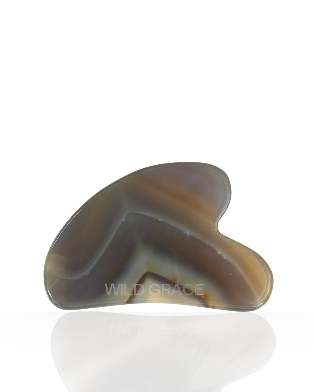 A curved gua sha massage tool made from polished agate with natural banding in brown, gray, and cream, featuring a &