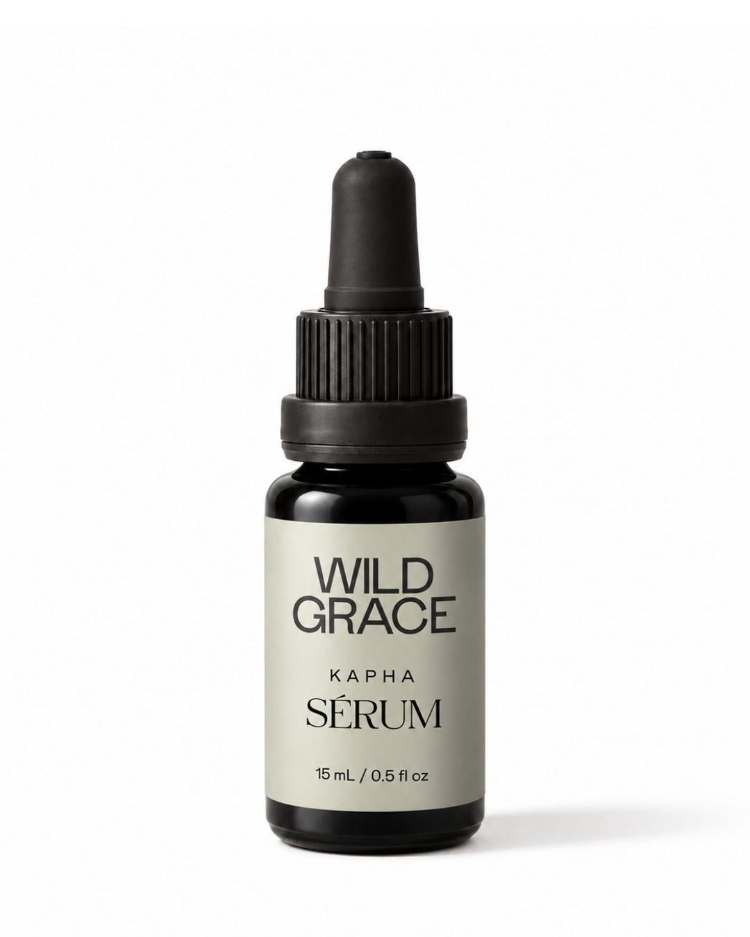 A small amber glass dropper bottle of Wild Grace Kapha Serum with a black dropper cap and a light gray label, centered on a white background.