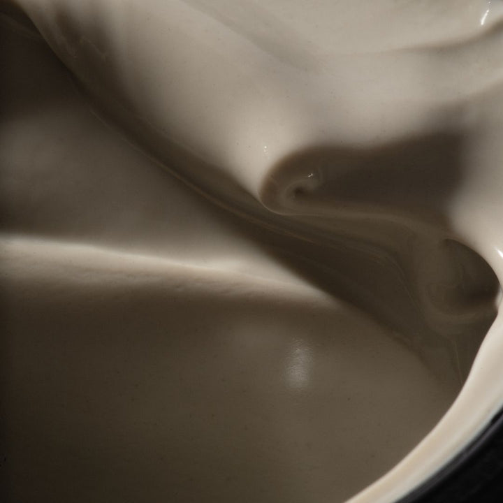 Close-up of a smooth, creamy mask texture with soft shadows