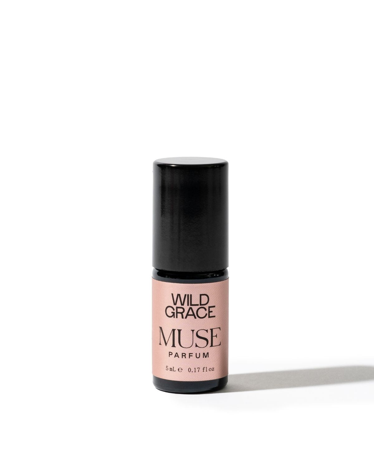 A 5ml bottle of Wild Grace Muse Parfum with a black cap and a dusty pink label, set against a plain white background with a soft shadow.