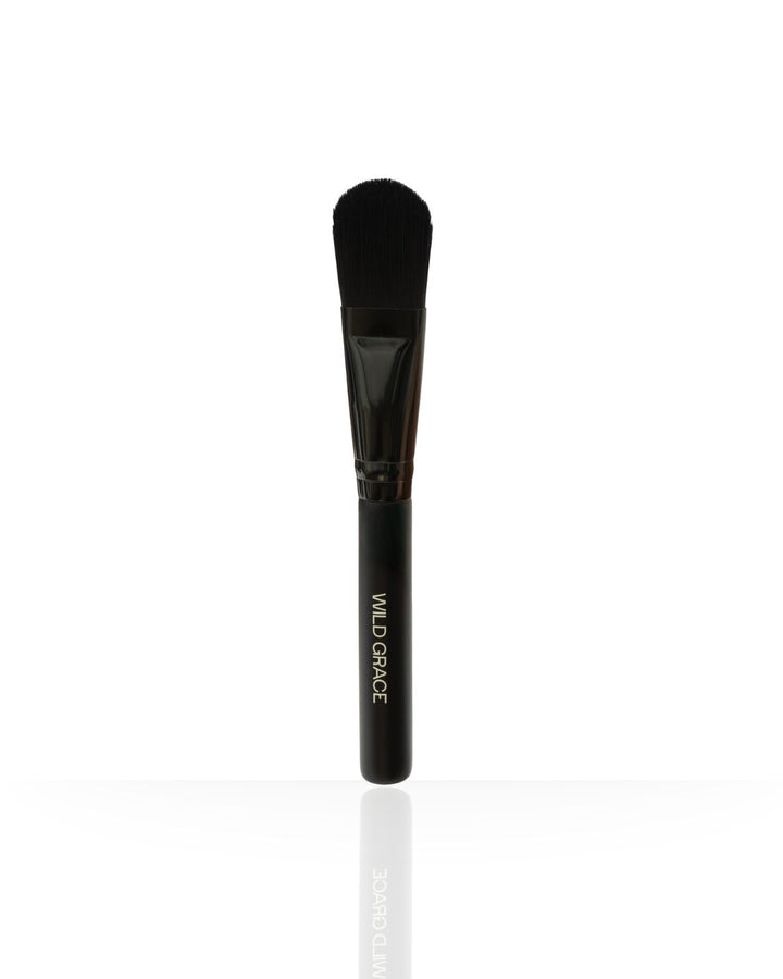Makeup brush with black handle and bristle head on a white background, branded &