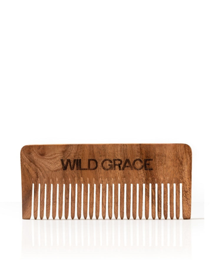 A wooden hair comb with the brand name &