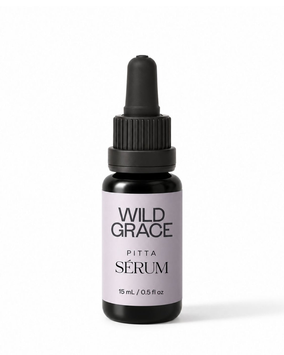A small dropper bottle of Wild Grace Pitta Sérum on a clean white background. The bottle is made of dark amber glass with a black dropper cap and features a light lavender label with black text.