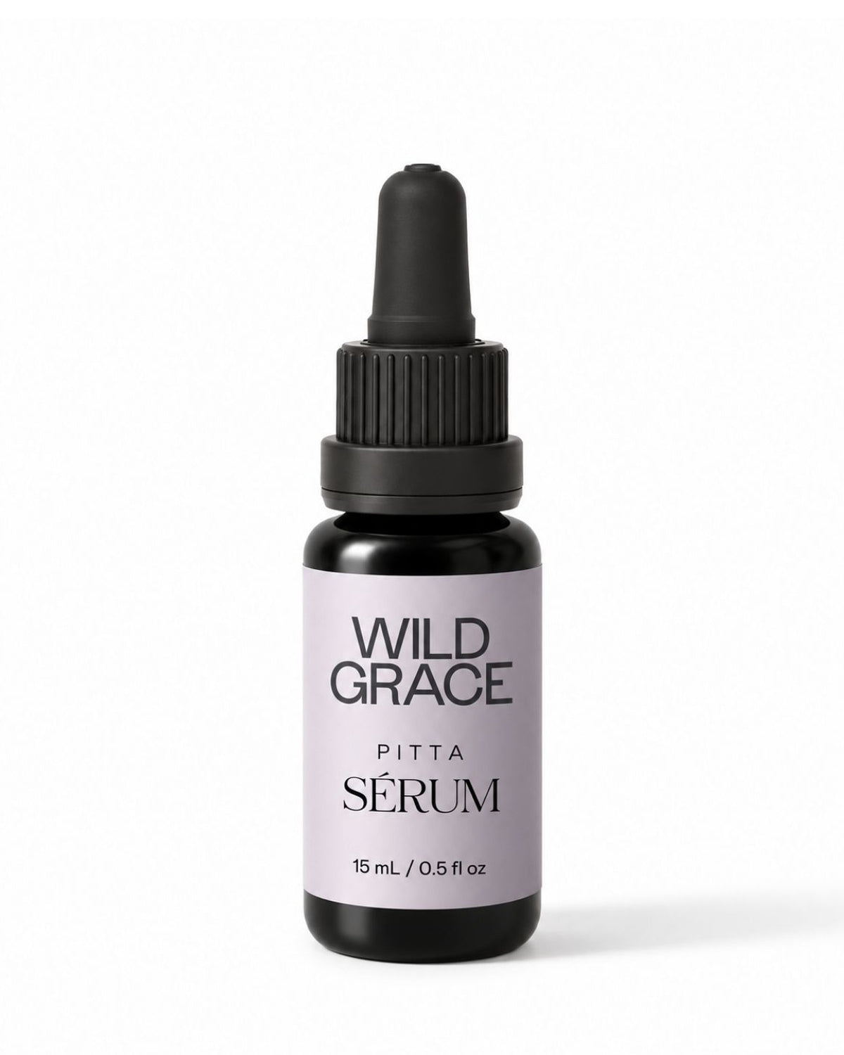 A small dropper bottle of Wild Grace Pitta Sérum on a clean white background. The bottle is made of dark amber glass with a black dropper cap and features a light lavender label with black text.