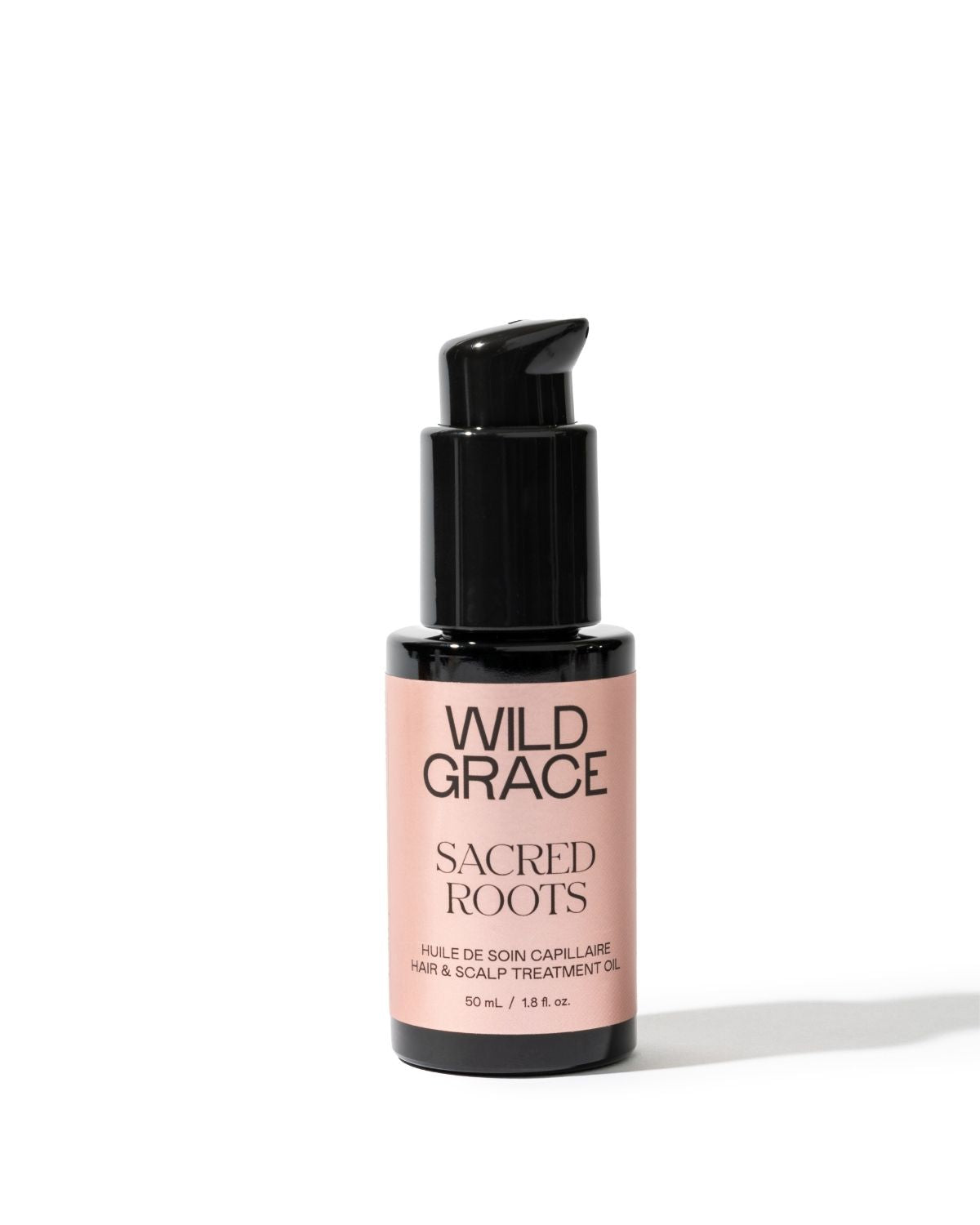 Bottle of Wild Grace Sacred Roots hair and scalp treatment oil on a white background