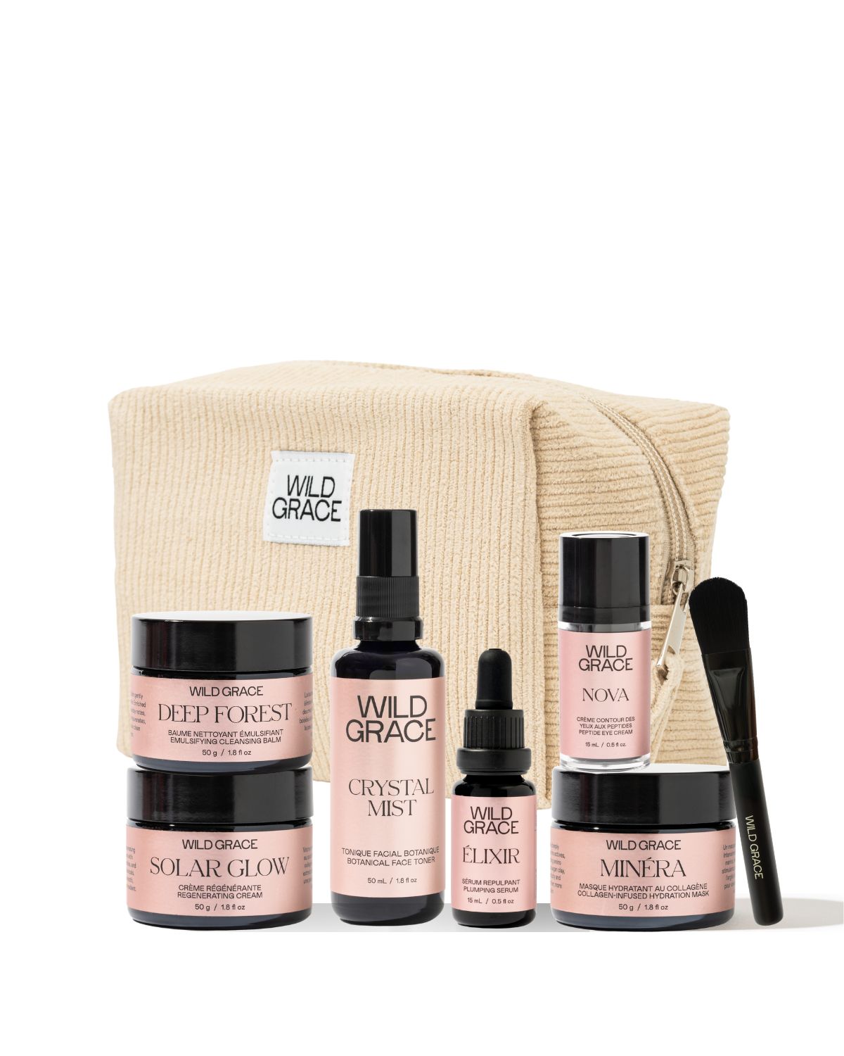 Wild Grace skincare gift set featuring five products (Deep Forest, Solar Glow, Crystalline Mist, Elixir, Minera) and a black applicator brush, arranged in front of a beige zippered pouch on a white background.