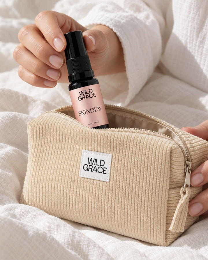 A beige corduroy zip pouch with a white &