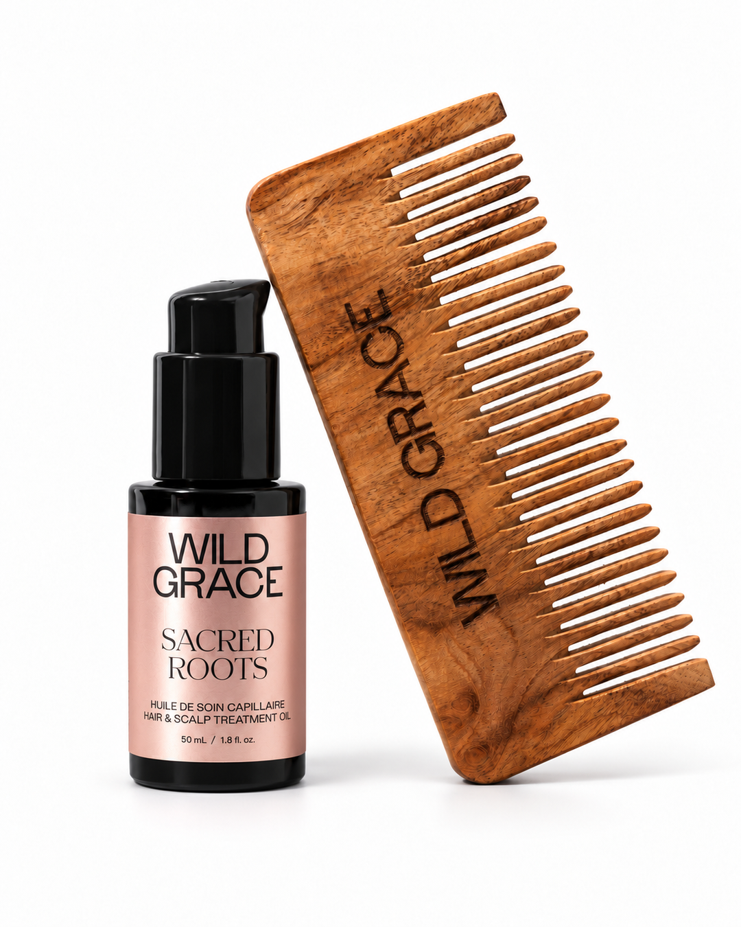 Wild Grace Sacred Roots hair care set featuring a wooden beard comb and a black pump bottle with a pink label, displayed on a clean white background.

