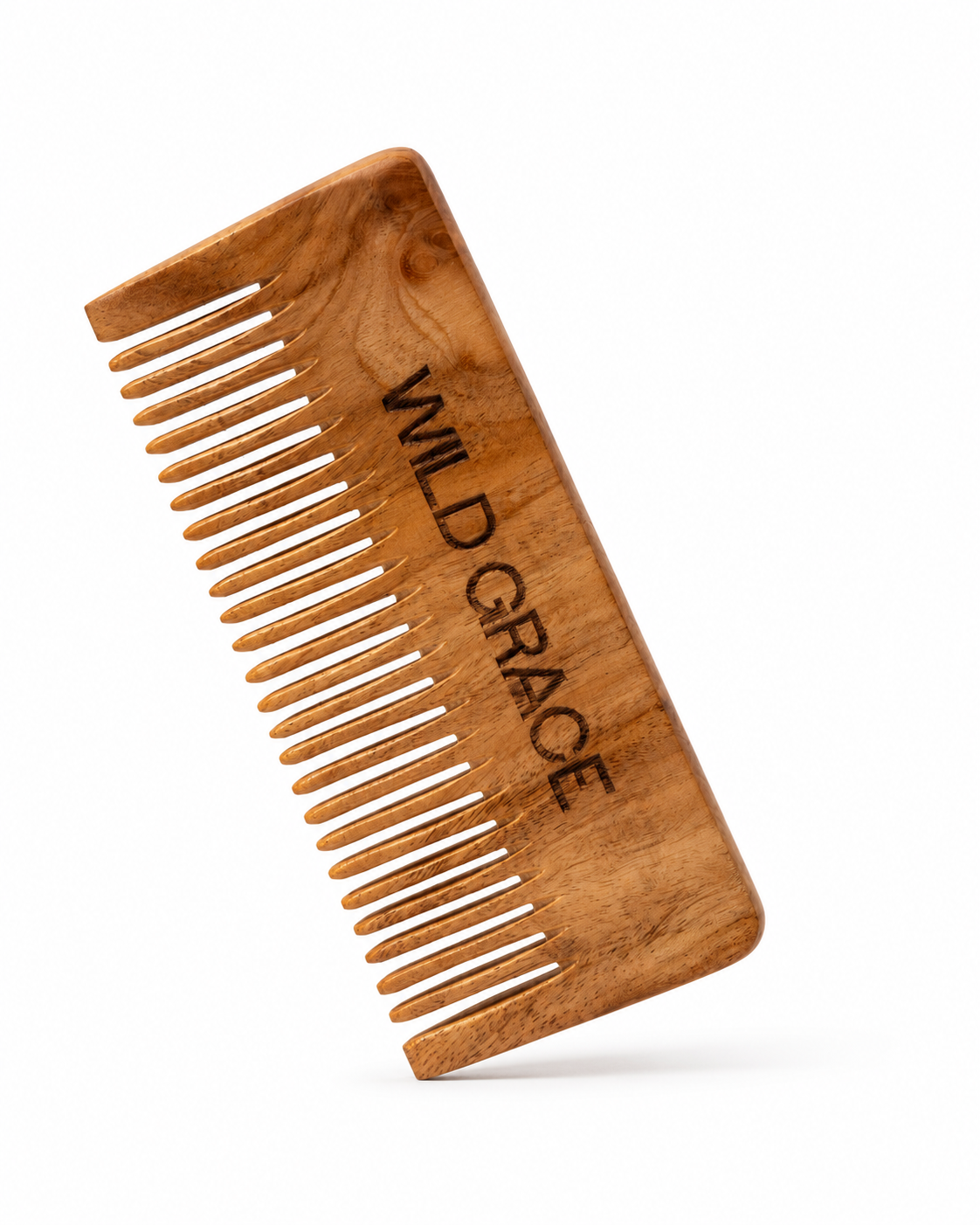 A wooden hair comb with the brand name 'WILD GRACE' engraved on the forehead, shown against a plain white background with a soft reflection below.