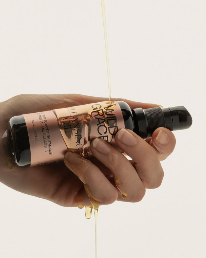 Hand holding a bottle of &