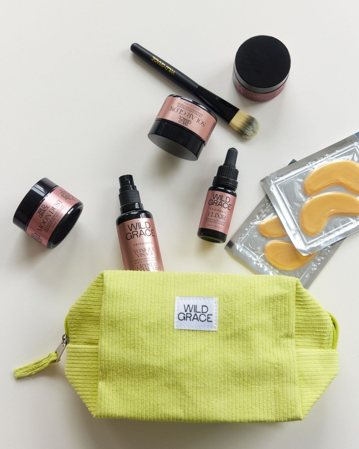 Yellow toiletry bag with 'Wild Grace' label on a white background