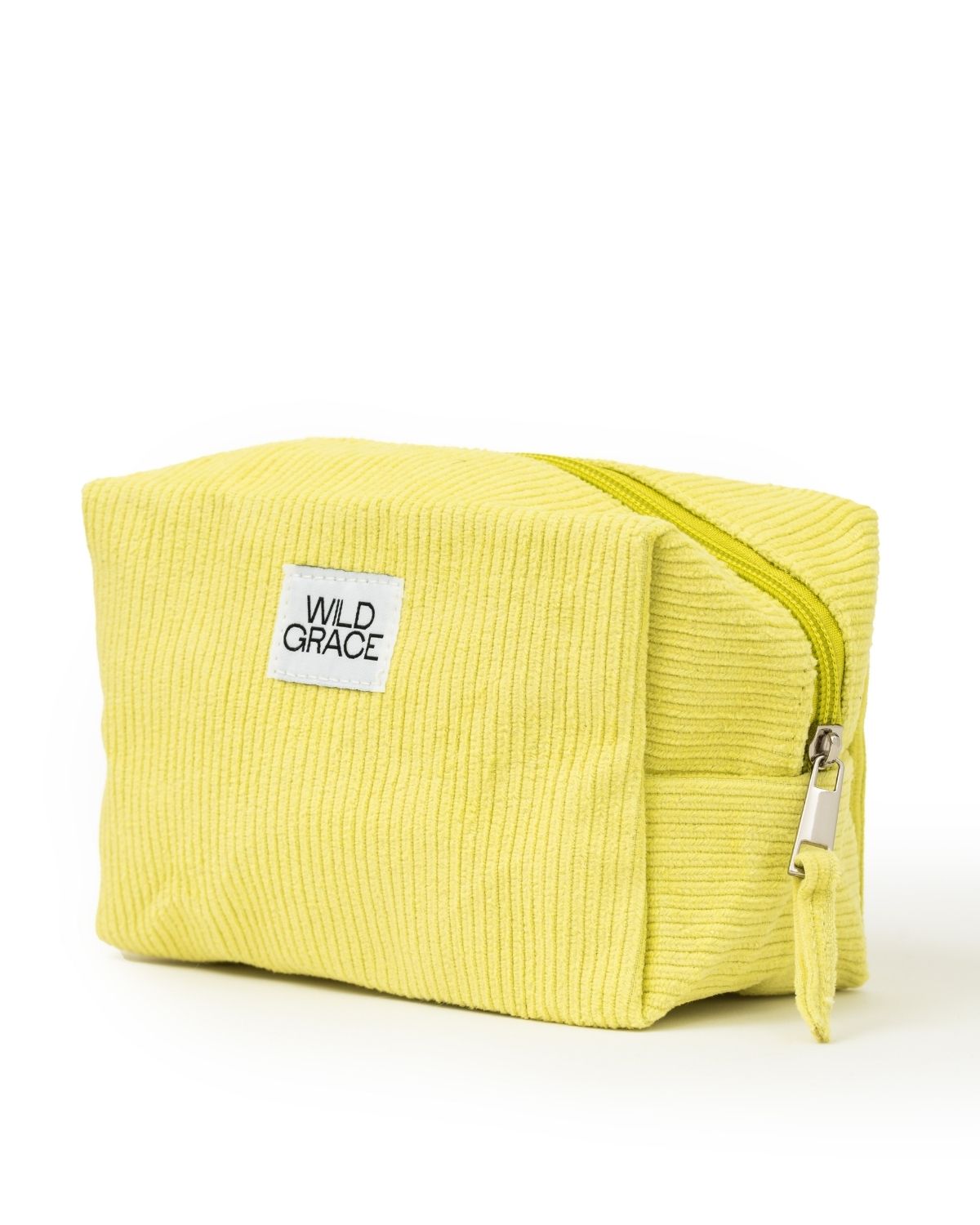 Yellow toiletry bag with 'Wild Grace' label on a white background