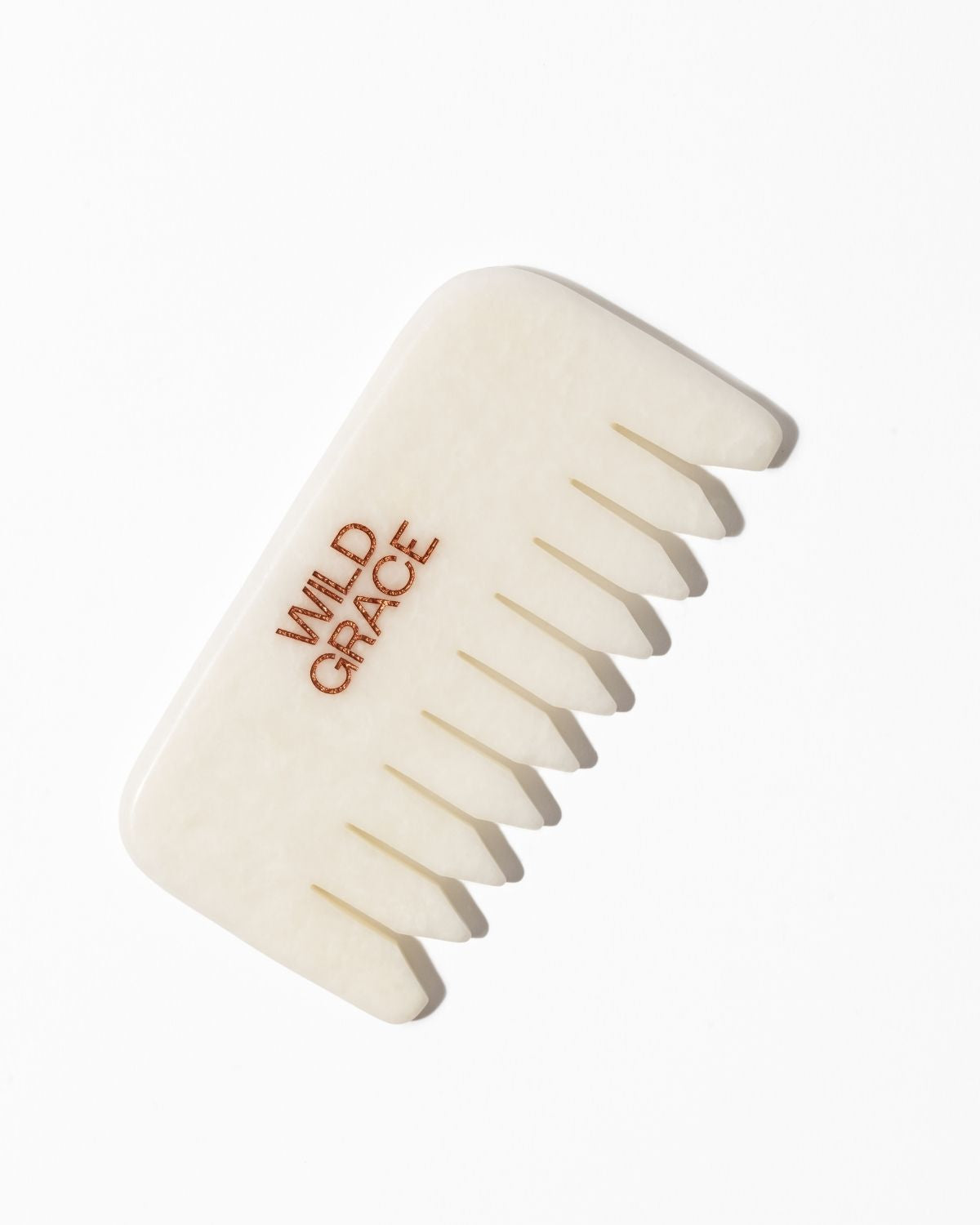White jade comb with 'Wild Grace' branding on a white background