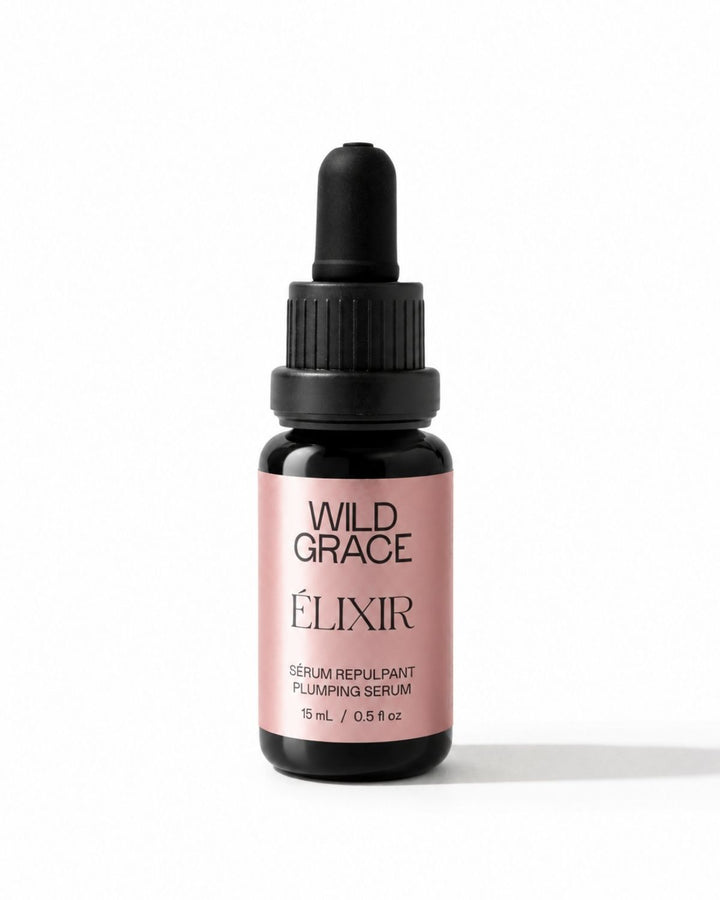 A small dropper bottle of Wild Grace Elixir Serum Repulant on a clean white background. The bottle is dark amber glass with a black dropper cap and a dusty pink label featuring black text.