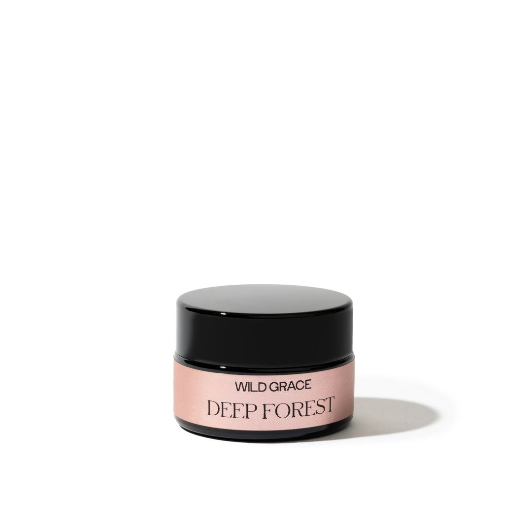 Cosmetic jar labeled 'Wild Grace Deep Forest' on a white background