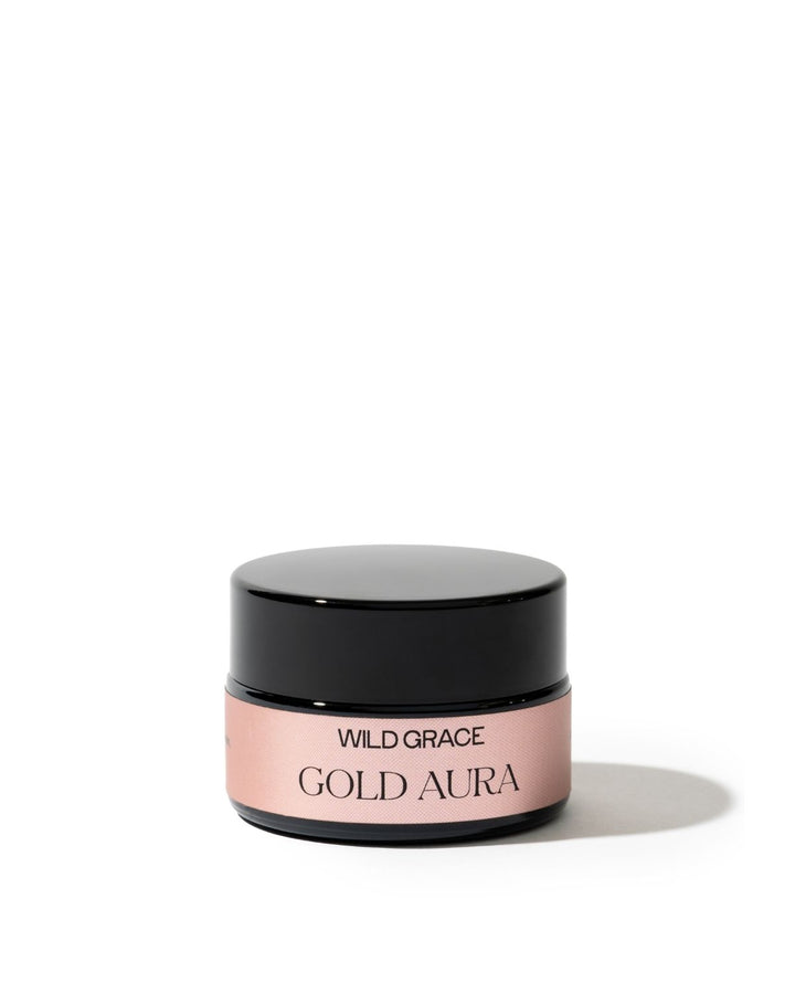 A small cosmetic jar with a glossy black lid and a dusty pink label reading &