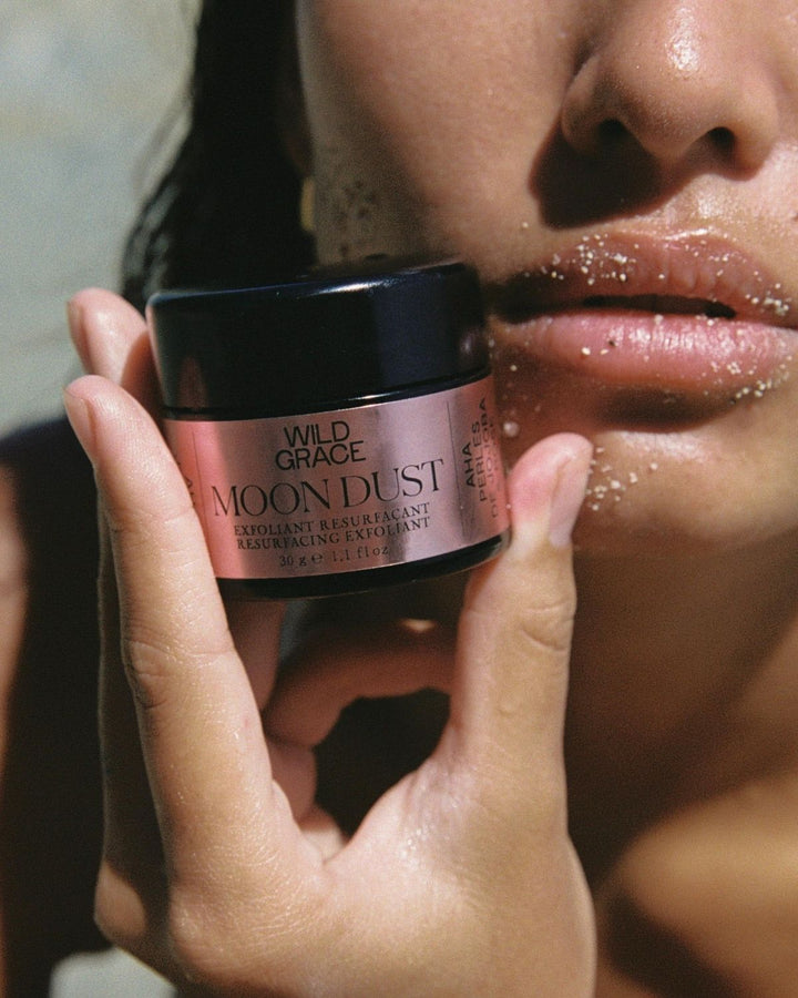 Person applying Wild Grace Moon Dust facial product to their face