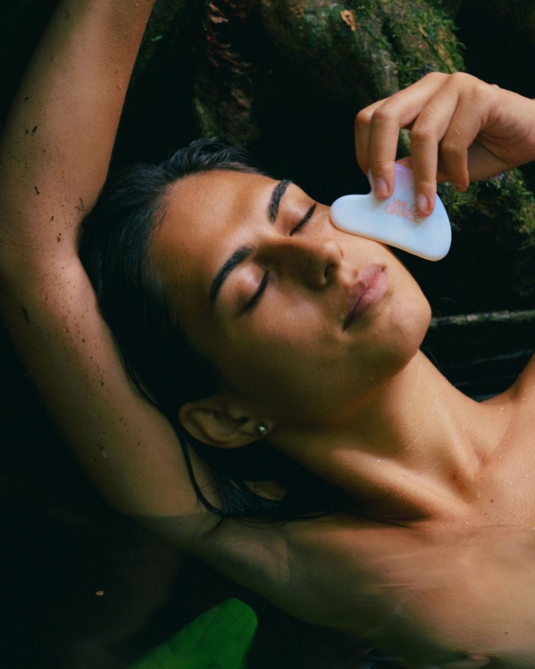 Person receiving a gua sha tool massage outdoors