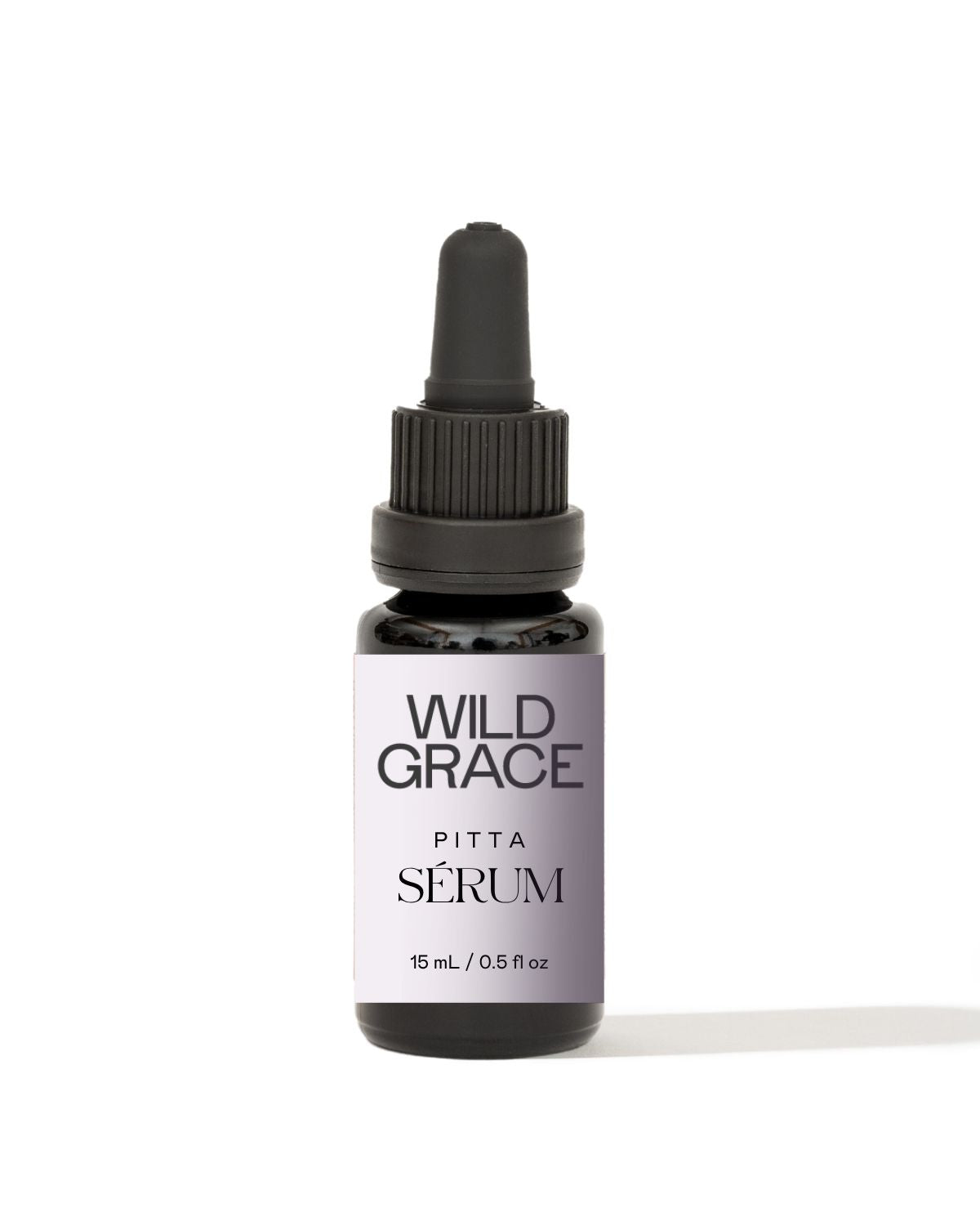 A small dark glass dropper bottle labeled 'WILD GRACE PITTA SÉRUM' on a clean white background with a soft shadow.