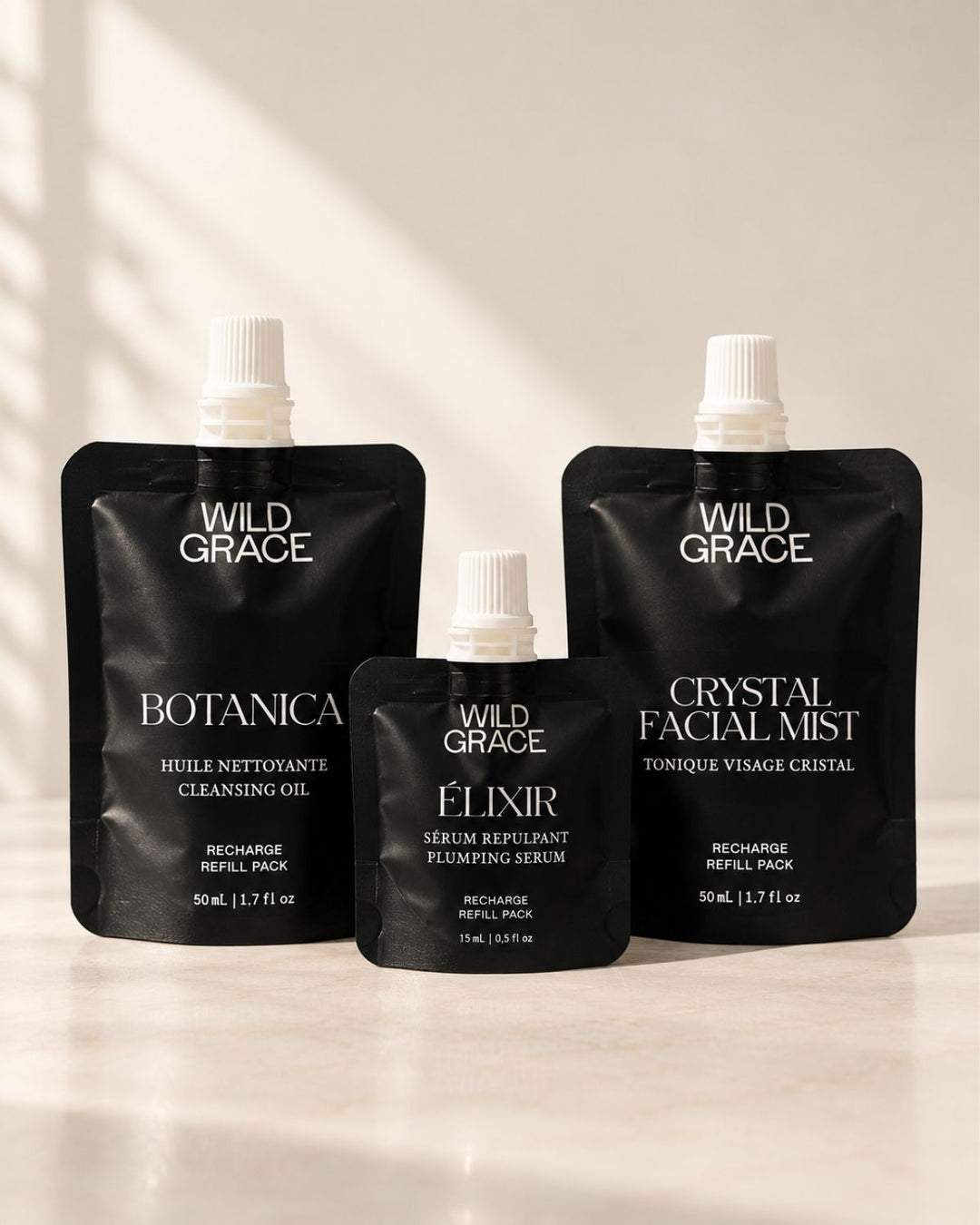 the three wild grace refill pouches on a light colored counter