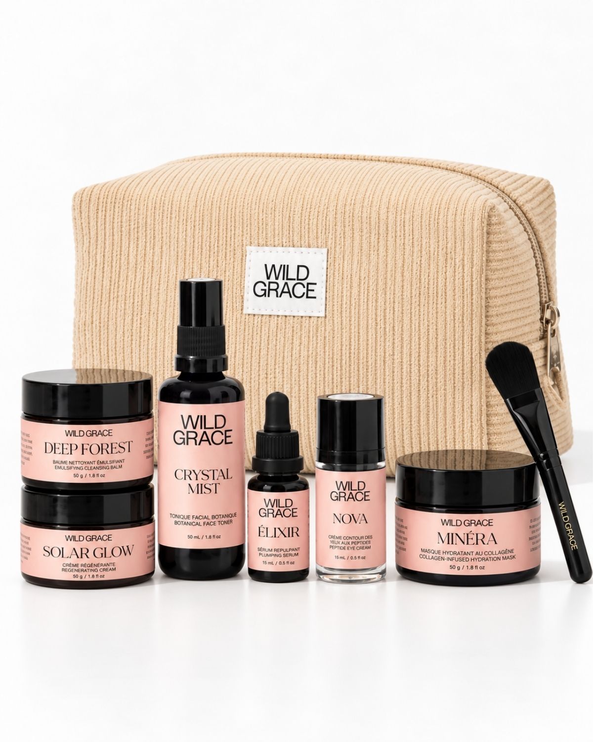 Wild Grace skincare gift set featuring five products (Deep Forest, Solar Glow, Crystalline Mist, Elixir, Minera) and a black applicator brush, arranged in front of a beige zippered pouch on a white background.